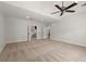Large bedroom with neutral carpeting, ceiling fan, and open doorways at 4290 Bobbins Way, Cumming, GA 30041