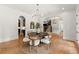 Light and bright dining room with modern chandelier and hardwood floors, perfect for entertaining and Gathering meals at 4290 Bobbins Way, Cumming, GA 30041
