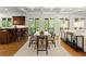 Open-concept dining area adjacent to living room and kitchen with views to the backyard from the French doors at 4290 Bobbins Way, Cumming, GA 30041