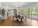 Bright dining room with hardwood floors, a modern chandelier, and access to the outdoor patio at 4290 Bobbins Way, Cumming, GA 30041