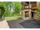Expansive covered outdoor living space with stone archways and well manicured landscaping at 4290 Bobbins Way, Cumming, GA 30041