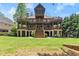 A well manicured lawn leads up to this home with multi-level decks and stone accents at 4290 Bobbins Way, Cumming, GA 30041