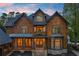 Charming home exterior featuring wood accents, stone details, and a welcoming front porch at 4290 Bobbins Way, Cumming, GA 30041