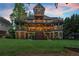 Stunning exterior elevation features multi-level balconies and patios with impeccable design and landscaping at 4290 Bobbins Way, Cumming, GA 30041