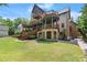 Multi-level back elevation with expansive decks, screened porch, manicured lawn and beautiful stone accents at 4290 Bobbins Way, Cumming, GA 30041