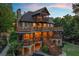 Multi-level home with expansive decks, stone base, inviting outdoor space, and natural surroundings at 4290 Bobbins Way, Cumming, GA 30041