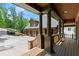 Inviting covered porch with wooden columns overlooking the front yard and driveway at 4290 Bobbins Way, Cumming, GA 30041