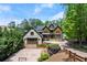Beautiful front exterior with ample parking, lush landscaping and basketball court at 4290 Bobbins Way, Cumming, GA 30041