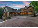Grand home front with spacious driveway, three-car garage, and lush landscaping at 4290 Bobbins Way, Cumming, GA 30041