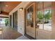 Covered front porch with brick accents, dark trim, and a grand entrance with glass-paneled doors at 4290 Bobbins Way, Cumming, GA 30041