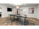 Game room with slate floors featuring a ping pong table, a television, and comfortable seating at 4290 Bobbins Way, Cumming, GA 30041