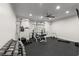 Well-equipped home gym featuring multiple machines, free weights, and a ceiling fan at 4290 Bobbins Way, Cumming, GA 30041