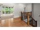 Hallway with wood floors and a view of the outside through glass patio doors at 4290 Bobbins Way, Cumming, GA 30041