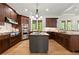 This gourmet kitchen boasts stainless steel appliances, custom cabinets, and a functional island for culinary enthusiasts at 4290 Bobbins Way, Cumming, GA 30041