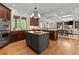 A gourmet kitchen features an island, stainless appliances, and views to an eat-in area at 4290 Bobbins Way, Cumming, GA 30041