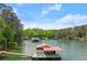 Lake view featuring boat dock and covered boat slip at 4290 Bobbins Way, Cumming, GA 30041