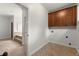 Spacious laundry area with tiled floor and direct access to bathroom at 4290 Bobbins Way, Cumming, GA 30041