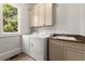 Bright laundry room with a sink, washer, dryer, and cabinets for storage at 4290 Bobbins Way, Cumming, GA 30041