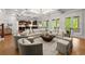 Spacious living room filled with natural light features elegant furnishings and seamless transition to the kitchen at 4290 Bobbins Way, Cumming, GA 30041