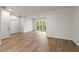 Living room includes hardwood floors, clean white walls and trim, with a view of nature from a private balcony at 4290 Bobbins Way, Cumming, GA 30041