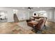 Spacious living room with slate flooring, plush brown couches, and staircase access at 4290 Bobbins Way, Cumming, GA 30041