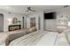 Spacious main bedroom features neutral tones, ceiling fan, tv, and a sitting area at 4290 Bobbins Way, Cumming, GA 30041