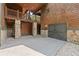 A large paved parking area leading to a two-door garage and wood exterior at 4290 Bobbins Way, Cumming, GA 30041