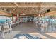 Spacious outdoor patio area featuring tables and chairs with a rustic overhead design at Pig Tales on Lake Lanier at 4290 Bobbins Way, Cumming, GA 30041
