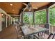 Spacious covered porch features an outdoor dining area with nature views at 4290 Bobbins Way, Cumming, GA 30041