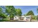An exterior view showcasing the backyard with a patio dining set for outdoor entertaining at 7580 Blacks Mill Rd, Cumming, GA 30028