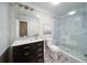 Stylish bathroom featuring a granite-topped vanity and tiled walk-in shower at 7580 Blacks Mill Rd, Cumming, GA 30028