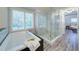 Bright bathroom featuring a soaking tub and glass-enclosed shower at 7580 Blacks Mill Rd, Cumming, GA 30028
