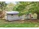 Well-maintained home with a metal roof, spacious deck, and manicured lawn at 7580 Blacks Mill Rd, Cumming, GA 30028
