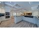 Spacious kitchen boasts white cabinets, modern stainless steel appliances, and a large granite island for cooking at 7580 Blacks Mill Rd, Cumming, GA 30028