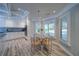 Eat-in kitchen features a breakfast table next to window, granite counters, and lots of natural light at 7580 Blacks Mill Rd, Cumming, GA 30028
