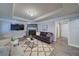 Cozy living room with a stone fireplace, comfortable seating, and a modern entertainment center at 7580 Blacks Mill Rd, Cumming, GA 30028
