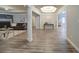 Open-concept living space with stone fireplace, neutral decor, and seamless flow to dining and kitchen areas at 7580 Blacks Mill Rd, Cumming, GA 30028