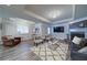 Comfortable living room featuring a stone fireplace, stylish furniture, and plenty of natural light at 7580 Blacks Mill Rd, Cumming, GA 30028