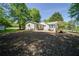 Charming single-story home with a patio for outdoor entertaining, surrounded by lush greenery and mature trees at 7580 Blacks Mill Rd, Cumming, GA 30028