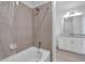 Bathroom featuring a tub, a grey tiled shower and a white vanity at 860 Peachtree Ne St # 2815, Atlanta, GA 30308