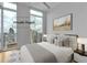 Virtually staged bedroom with a large window, a plush bed, and a view of the city skyline at 860 Peachtree Ne St # 2815, Atlanta, GA 30308