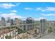 A high-rise balcony provides stunning views of the city skyline under a blue sky at 860 Peachtree Ne St # 2815, Atlanta, GA 30308