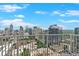 A stunning daytime cityscape view from a high-rise balcony with blue skies and a mix of modern and classic architecture at 860 Peachtree Ne St # 2815, Atlanta, GA 30308