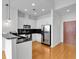 Modern kitchen with white cabinets, stainless steel appliances, wood floors, and a breakfast bar at 860 Peachtree Ne St # 2815, Atlanta, GA 30308