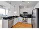 Modern kitchen featuring white cabinets, stainless steel appliances, black subway tile, and an island with countertop seating at 860 Peachtree Ne St # 2815, Atlanta, GA 30308