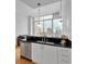 Modern kitchen featuring white cabinets, black granite countertops, and stainless steel appliances, with a city view at 860 Peachtree Ne St # 2815, Atlanta, GA 30308