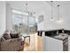 Modern living room featuring floor-to-ceiling windows, hardwood floors, a comfortable couch, and stylish lighting at 860 Peachtree Ne St # 2815, Atlanta, GA 30308