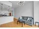Bright living area with hardwood floors, modern lighting, and an adjacent kitchen with stainless steel appliances at 860 Peachtree Ne St # 2815, Atlanta, GA 30308