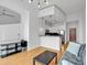 Open-concept living room with high ceilings, hardwood floors, a kitchen bar, and modern lighting at 860 Peachtree Ne St # 2815, Atlanta, GA 30308