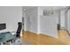 Open living area with hardwood floors, a modern desk, and a view into other rooms at 860 Peachtree Ne St # 2815, Atlanta, GA 30308